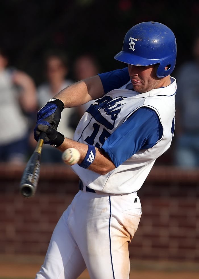 The Art of Drawing Readers In: Your attractive post title goes here Dynamic shot of a baseball player swinging a bat during a game, wearing a blue and white uniform.